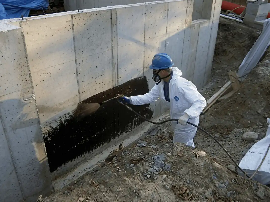 Professional waterproofing the exterior walls of the basement in Akron, OH