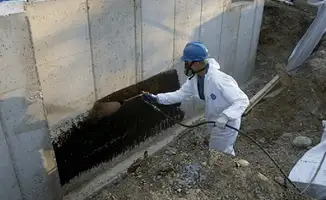Professional waterproofing the exterior walls of the basement in Akron, OH
