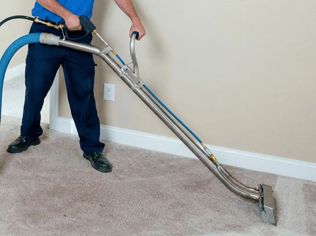 Professional operating a liquid removal machine on a carpeted floor in Akron, OH
