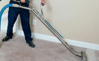 Professional operating a liquid removal machine on a carpeted floor in Akron, OH